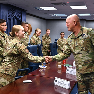 Photo of Cadet Savage shaking hands